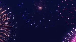 Two girls were doing it while watching fireworks. Another girl was watching them.