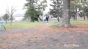 peeing behind a tree in the park